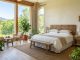 Bright eco friendly hotel room with wooden furniture and natural sunlight.